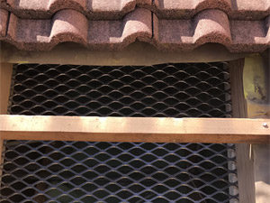 Tile roof secured with Burglar Baffle roof security barrier.